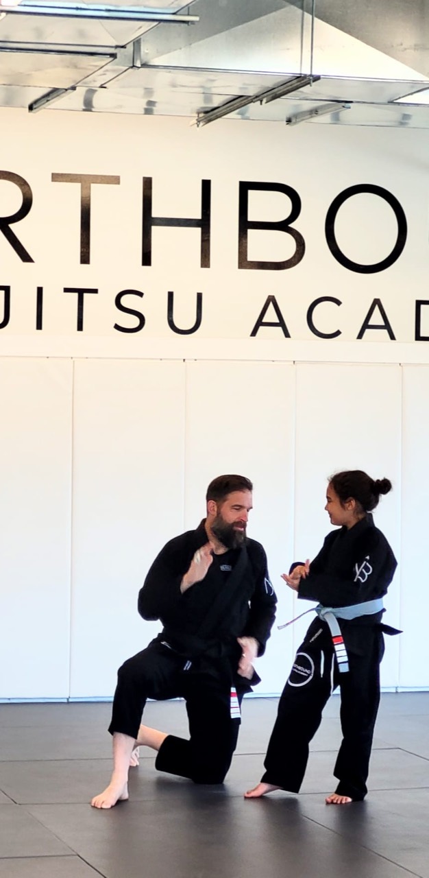 Northbound Jiu-Jitsu instructor working with a youth student